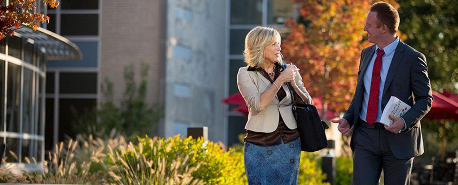 A couple walking across campus